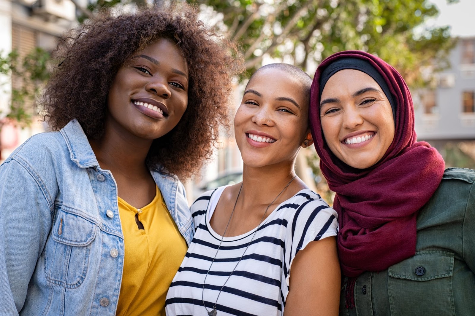 3 multiracial women smiling