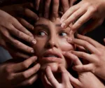 I feel trapped. Shot of hands grabbing a young womans against a dark background