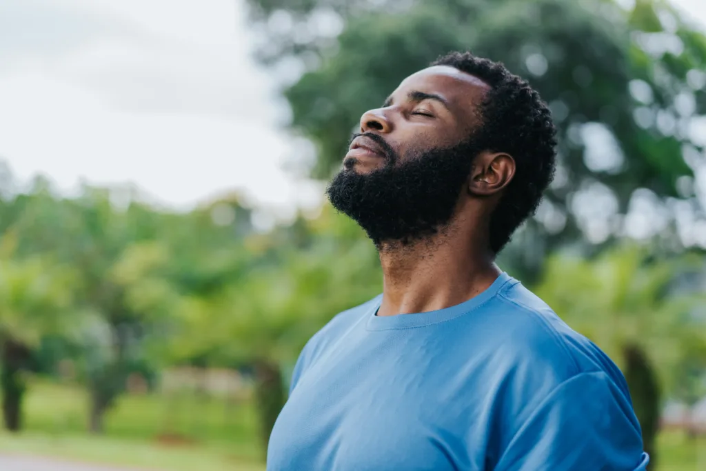 Portrait of a man breathing fresh air in nature