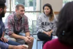 mid-adult-male-veterans-discusses-war-experiences-during-a-support-group-meeting-for-veterans-stockpack-gettyimages-scaled-jpg