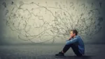 boy sitting on the ground thinking and looking upset and tired