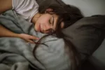 young-woman-sleeping-in-bedroom-stockpack-gettyimages-scaled-jpg